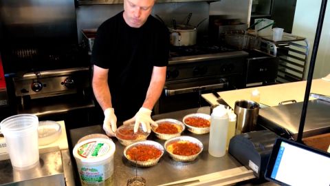 A chef at La Riv, pictured here in April last year, packages free meals for Texans struggling during the pandemic. 