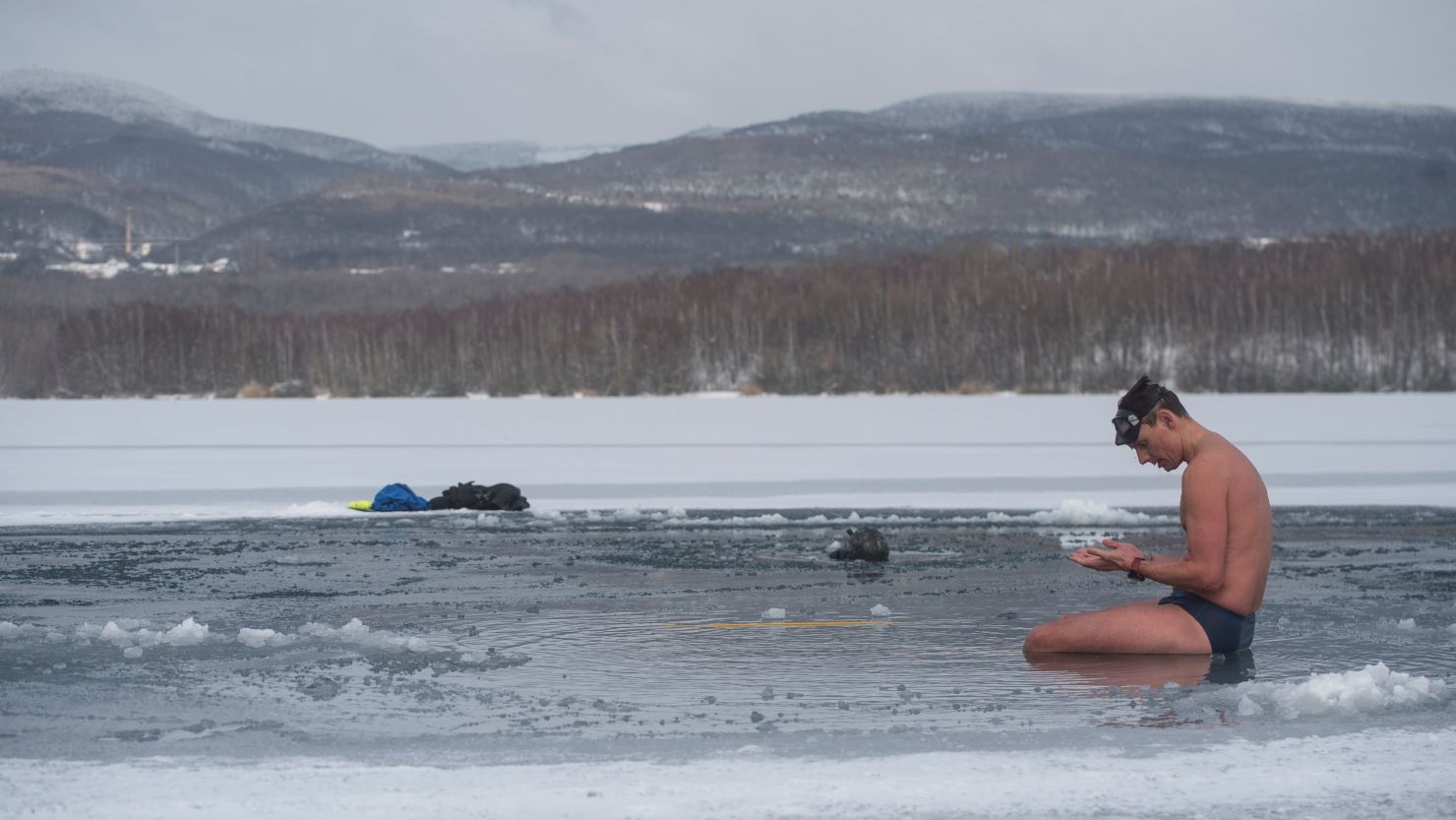Czech freediver David Vencl rests on the icy Barbora lake near Teplice city, Czech Republic, on February 13, 2021 after his training to break the Guinness world record for the longest swim under ice.