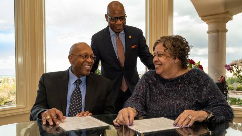 Calvin and Tina Tyler, with Morgan State President David Wilson, pledged $20 million to the school to create more need-based scholarships.