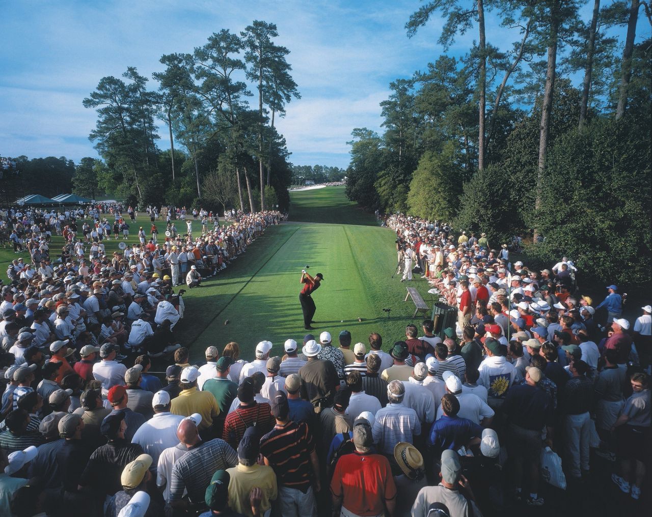 Fans watch Woods tee off on the 18th hole at the 2001 Masters. Woods went on to win the event and complete what's now called the Tiger Slam — four consecutive major titles.