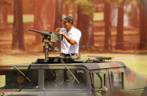Woods arrives in a military vehicle before a golf exhibition in Fort Bragg, North Carolina, in 2004. Woods spent the week training with Army troops before hosting a junior golf clinic for his Tiger Woods Foundation. Woods' father, Earl, was stationed at the base in the 1960s.