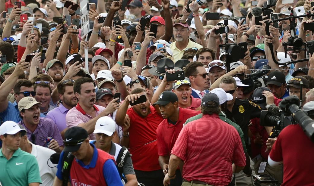 Woods is trailed by jubilant fans during the final round of the Tour Championship in Atlanta in 2018. It was <a href=