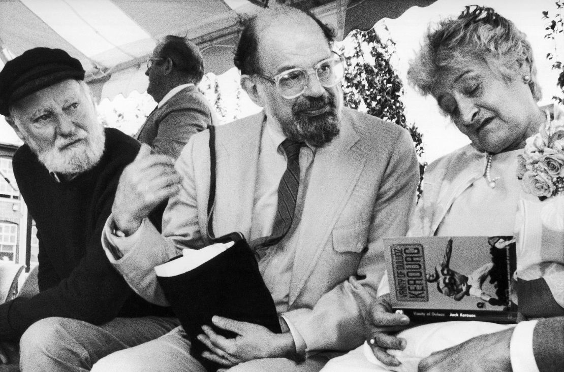 Poets Lawrence Ferlinghetti, left, and Allen Ginsberg look on as Stella Kerouac, right, autographs one of her late husband's book in  1988. 