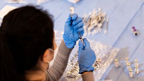 A pharmacist fills syringes with doses of Pfizer's Covid-19 vaccine at a pop-up community vaccination center in Valley Stream, New York, this month