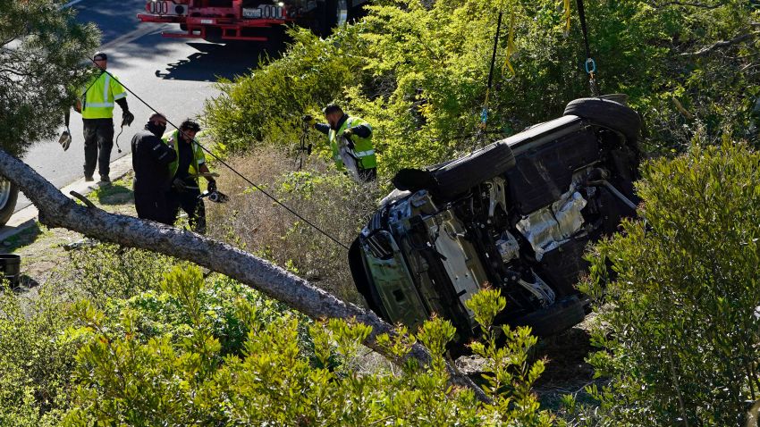 A vehicle rests on its side after a rollover accident involving golfer Tiger Woods Tuesday, Feb. 23, 2021, in the Rancho Palos Verdes suburb of Los Angeles. Woods suffered leg injuries in the one-car accident and was undergoing surgery, authorities and his manager said.