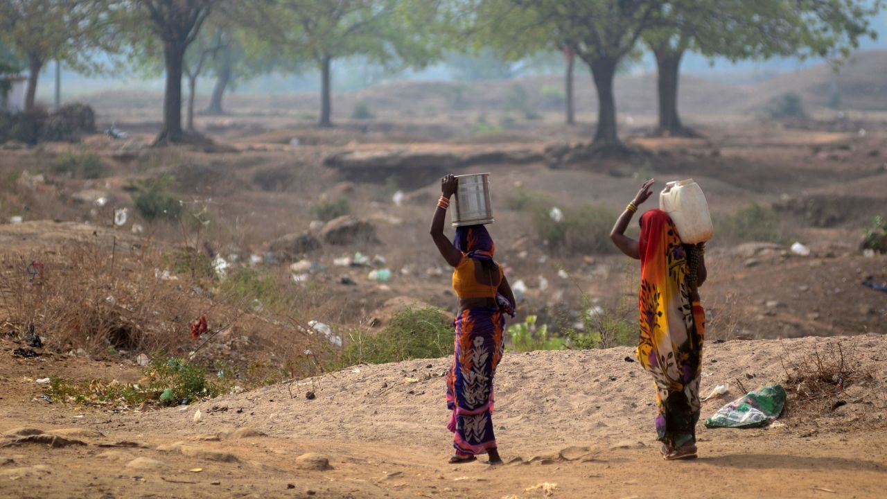 Indian women carrying drinking water from a municipal water tanker in Shankargarh, Uttar Pradesh, on June 6, 2019. 