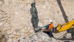 A local worker removes a statue of former Spanish dictator Francisco Franco, the last one remaining in Spain, from its location in Melilla, Spain, February 23, 2021.REUTERS/Jesus Blasco de Avellaneda