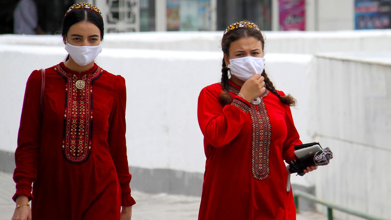 Turkmen women wearing face masks walk in Ashgabat on July 13, 2020.