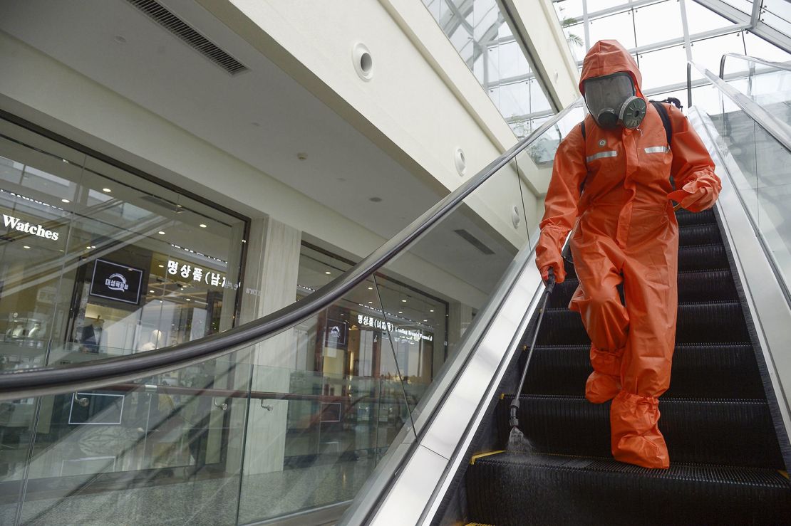 A worker sprays disinfectant at a department store in Pyongyang on August 7, 2020, amid concerns over the coronavirus.
