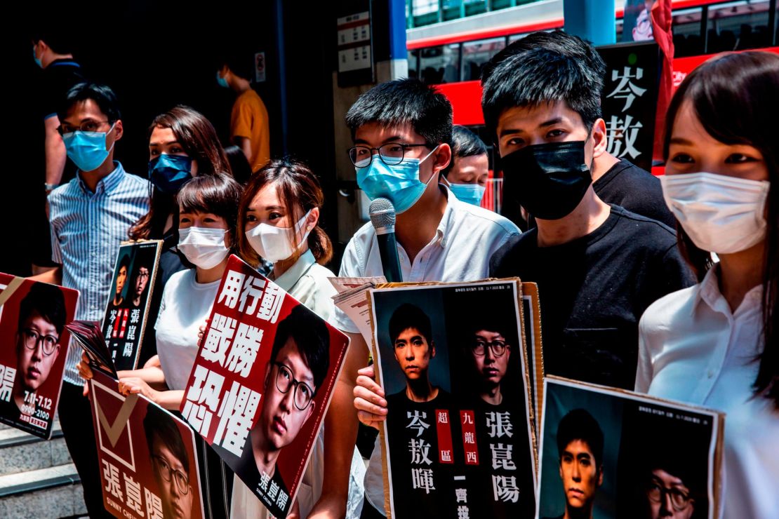 (L-R) Pro-democracy activists Eddie Chu, Gwyneth Ho, Leung Hoi-ching, Tiffany Yuen, Joshua Wong, Lester Shum and Agnes Chow campaign during primary elections in Hong Kong on July 12, 2020. - Pro-democracy parties in Hong Kong held primary polls on July 11 and 12 to choose candidates for upcoming legislative elections despite warnings from government officials that it may be in breach of a new security law imposed by China. (Photo by ISAAC LAWRENCE / AFP) (Photo by ISAAC LAWRENCE/AFP via Getty Images)