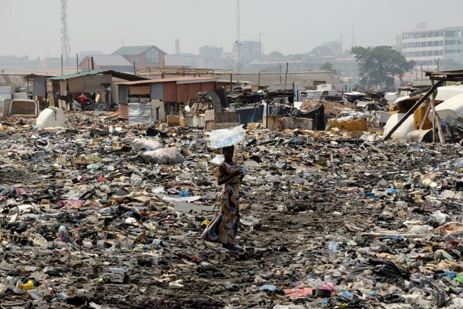 E-waste, along with other waste, carpets the ground in Agbogbloshie's scrapyard. The surrounding area is Ghana's largest informal settlement, known as Old Fadama. A 2011 <a href="index.php?page=&url=https%3A%2F%2Fwww.amnesty.org%2Fdownload%2FDocuments%2F24000%2Fafr280032011en.pdf" target="_blank" target="_blank">Amnesty International report</a> estimated as many as 79,000 people live there.