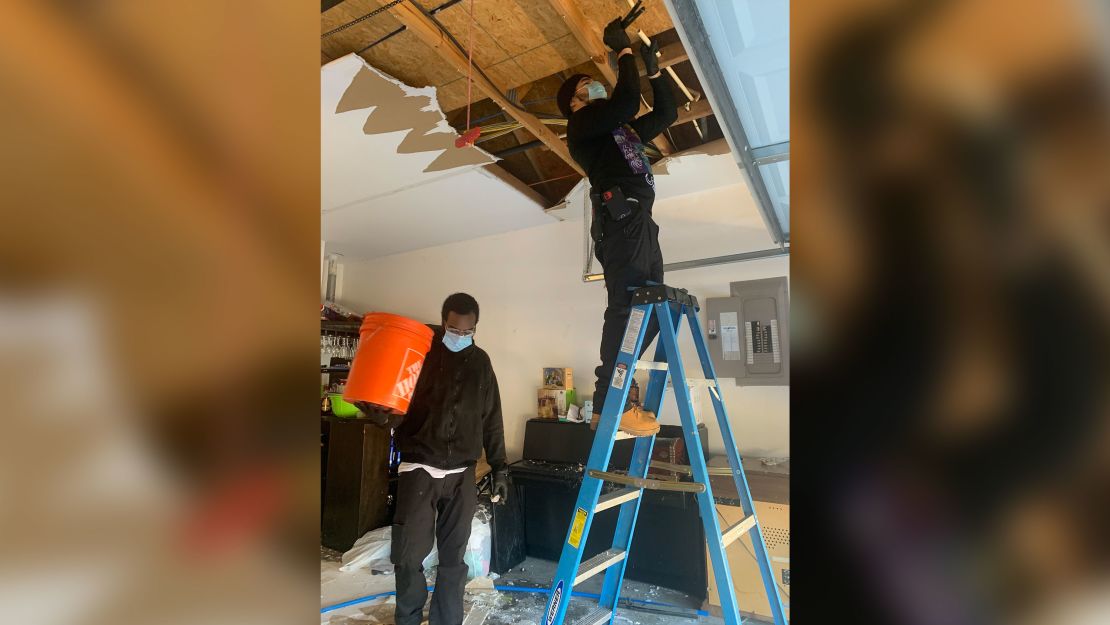Andrew Mitchell, right, and Isaiah Pinnock work in a customer's home in Texas.