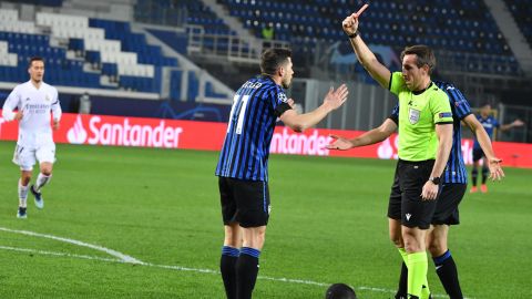 German referee Tobias Stieler shows a red card to Atalanta's Remo Freuler.