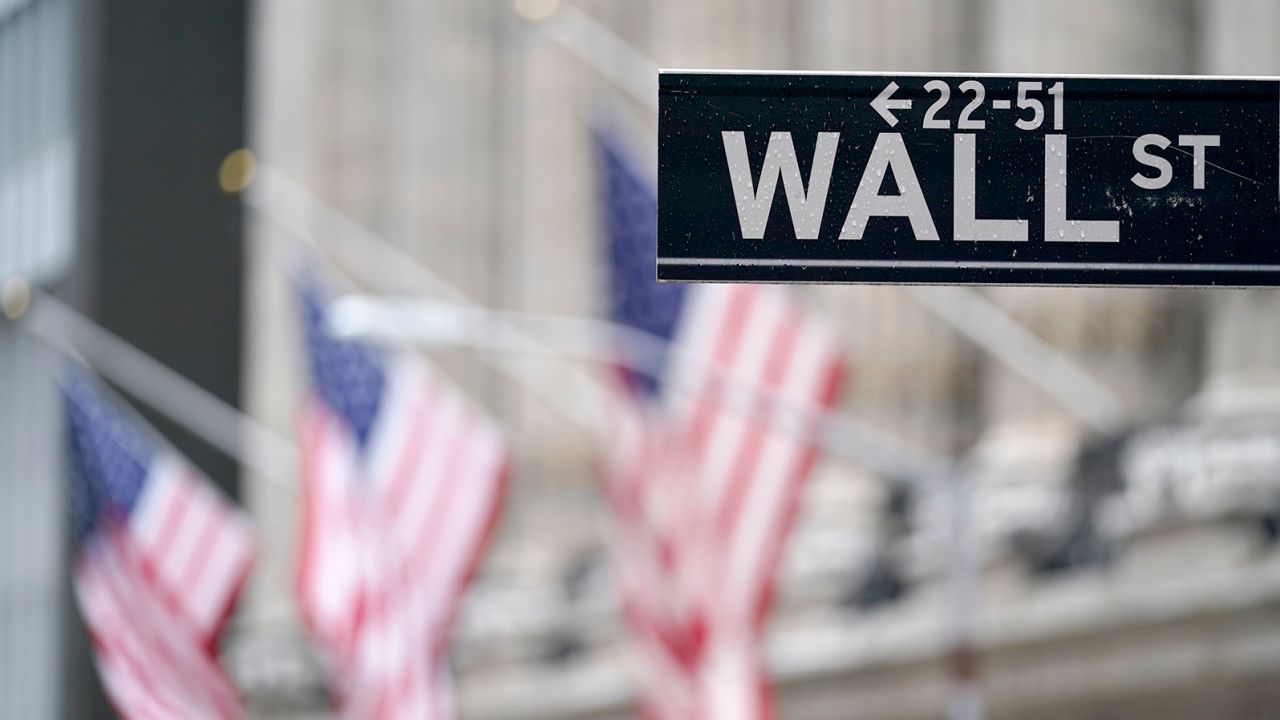 American flags hang oustside of the New York Stock Exchange Tuesday, Feb. 16, 2021, in New York. (AP Photo/Frank Franklin II)