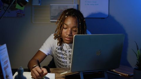 Kearra Johnson, owner of Studio Lo, working at her desk.
