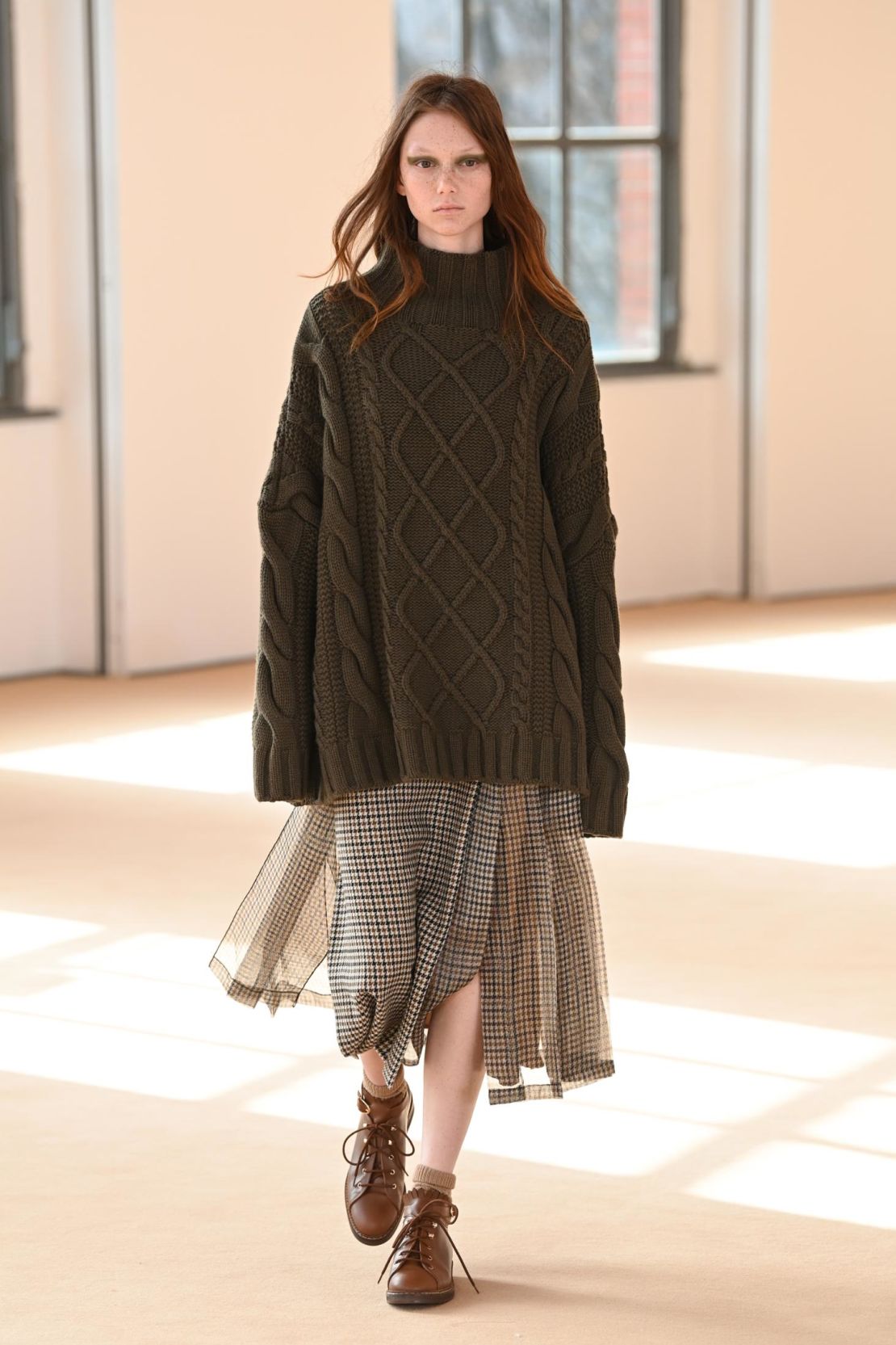 According to the show notes, the collection is an "urban country-mix" with cocooning aran knits and slouchy tartan skirts.