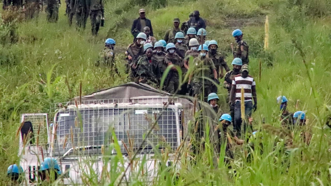 United Nations peacekeepers remove bodies from the area of the attack in North Kivu province on Monday