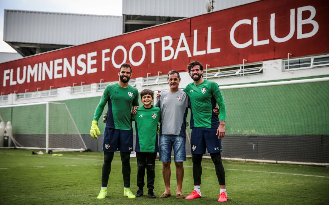 Liverpool goalkeeper Alisson (R) and brother Muriel (L) with father Jose Becker (2-R).