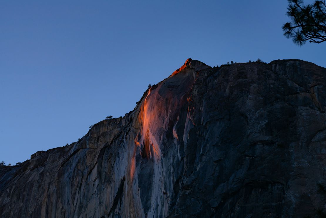 The rays of the setting sun create a pinkish-orange hue at firefall in Yosemite on Wednesday, February 24.