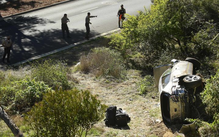 Law enforcement officers investigate the scene of <a href="https://www.cnn.com/2021/02/24/us/tiger-woods-car-accident-wednesday-intl-spt/index.html" target="_blank">Tiger Woods' rollover crash</a> in Rancho Palos Verdes, California, on Tuesday, February 23. <a href="http://www.cnn.com/2021/02/23/golf/gallery/tiger-woods/index.html" target="_blank">The golf icon</a> sustained serious leg injuries in the accident.