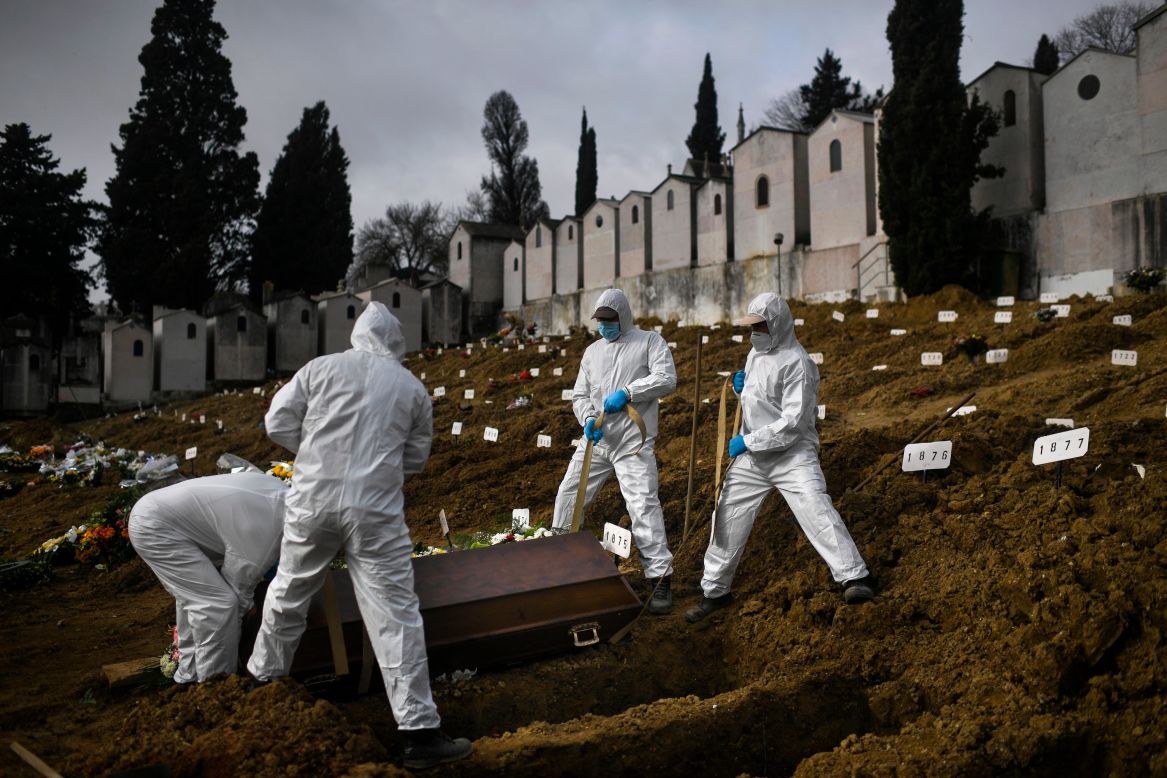 Gravediggers bury a Covid-19 victim at a cemetery in Lisbon, Portugal, on Thursday, February 18.