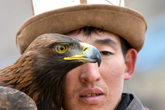 A man holds a golden eagle during the Salburun hunting festival in Tuura-Suu, Kyrgyzstan, on Tuesday, February 23.