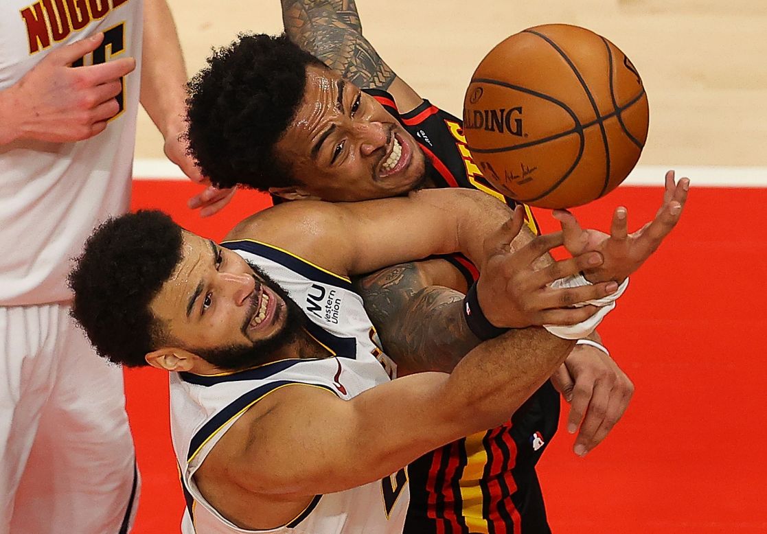 Denver's Jamal Murray, left, and Atlanta's John Collins battle for a rebound during an NBA game in Atlanta on Sunday, February 21.