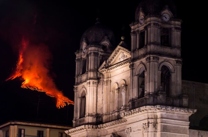 Mount Etna, Europe's most active volcano, spews lava, ash and volcanic rock behind the Mother Church in Zafferana Etnea, Italy, on Wednesday, February 24.
