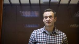 Russian opposition leader Alexei Navalny stands in a cage in the Babuskinsky District Court in Moscow, Russia, Saturday, Feb. 20, 2021. A Moscow court on Saturday considered Navalny's appeal against his prison sentence as the country faced a top European rights court's order to free the most prominent Kremlin foe. (AP Photo/Alexander Zemlianichenko)