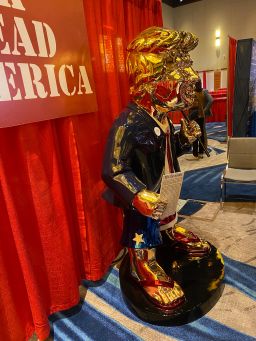A golden Trump statue is displayed at the 2021 Conservative Political Action Conference
