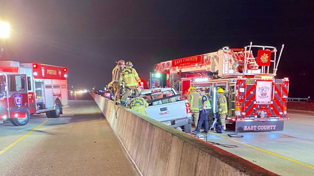 Firefighters examine a vehicle involved in a fatal accident on Interstate 59 in Texas on Thursday, February 25.