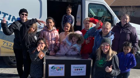 The Girl Scouts of Troop 64224, seen here with Beth Shelton, CEO of Girl Scouts of Greater Iowa, sold more than 5,000 cookies, even though the girls live in an emergency shelter. 
