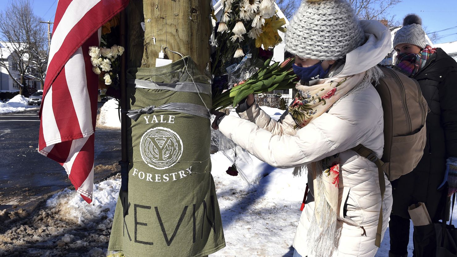 Yale postdoctoral students Maria Kochugaeva, left, and Elvira Mulyukova leave flowers at a memorial for Kevin Jiang on Feb. 28, 2021.