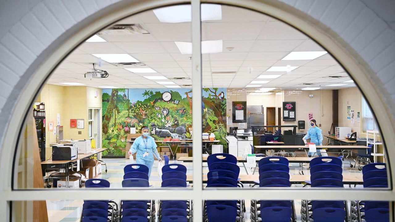 Workers clean work spaces for teachers in what was previously used as the cafeteria at Key Center on Tuesday February 16, 2021, in Springfield, Virginia. 