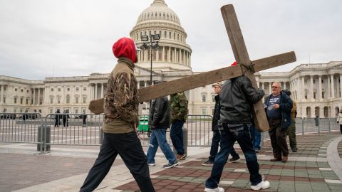 Pro-Trump supporters carry a wooden cross in front of the US Capitol on January 6.
