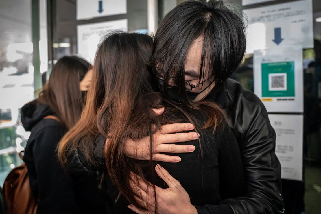 Mike Lam King-nam, who participated in the pro-democracy primary elections, gives a hug to his wife ahead of reporting the Ma On Shan Police Station on February 28, in Hong Kong.