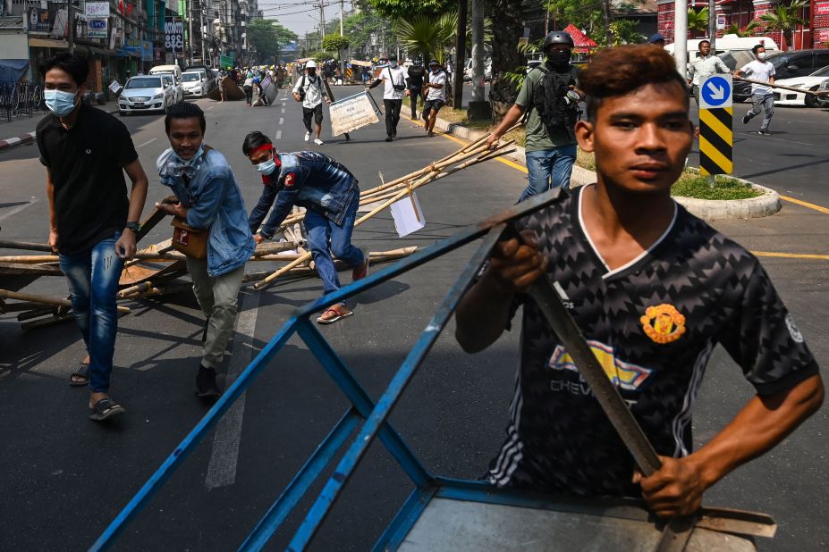 Protesters erect barricades during a demonstration in Yangon on February 28.