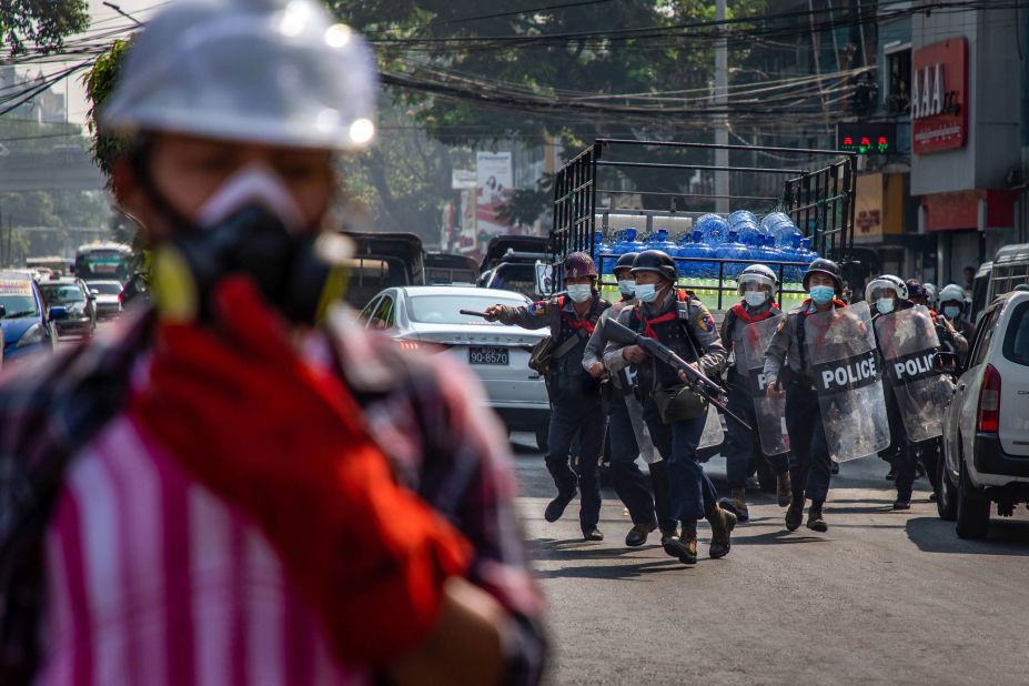 Police charge at anti-coup protesters in Yangon on February 27.