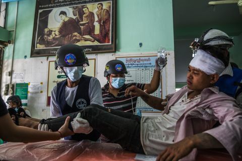An injured protester receives medical attention in Mandalay after police and military forces cracked down on protests on February 26.