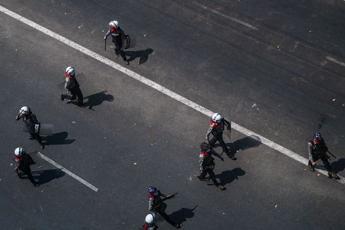 Police walk on a street in Yangon on February 28 as security forces continue to crackdown on demonstrations by protesters against the military coup.