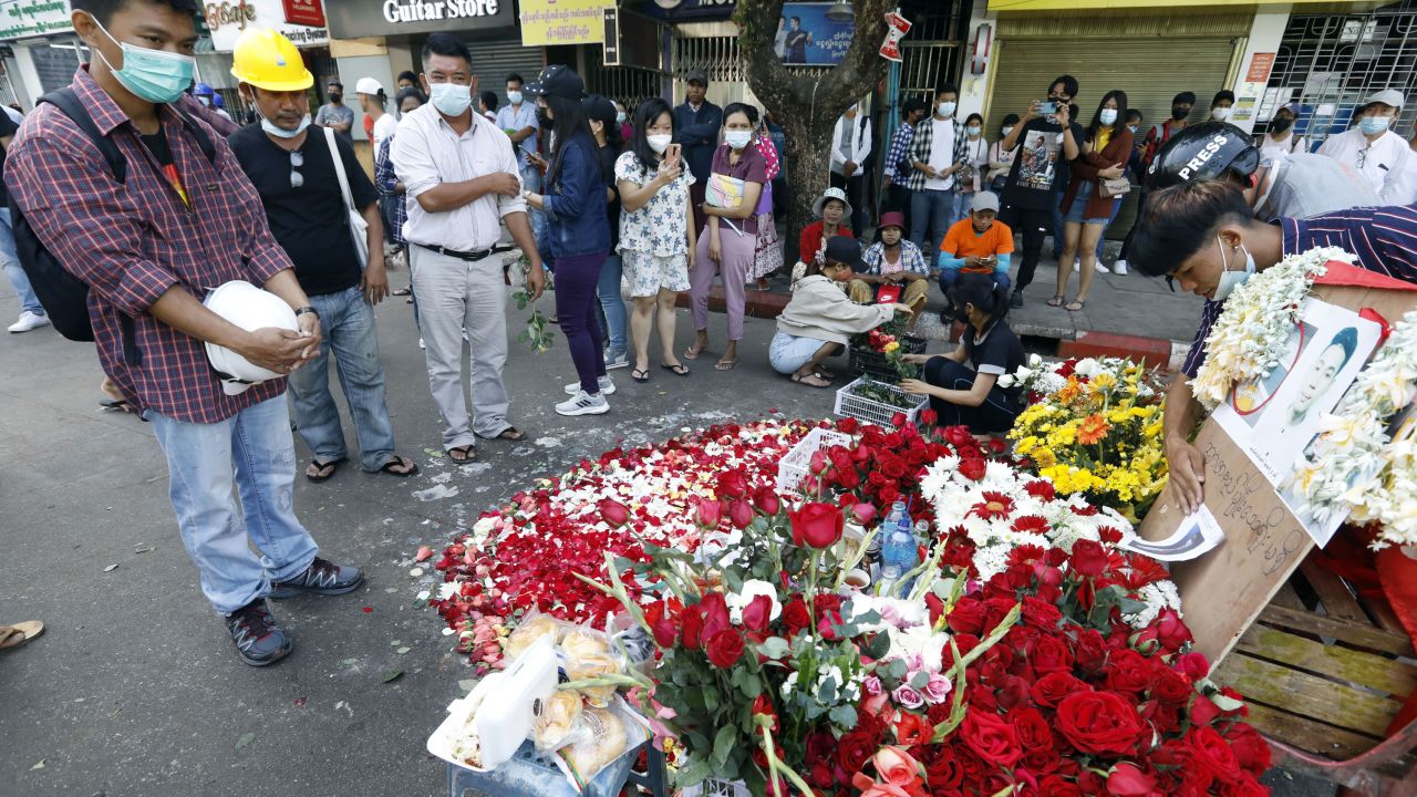 People attend a prayer for a young protester who was killed during a crackdown on anti-coup protesters, near Hledan junction in Yangon on March 1. 