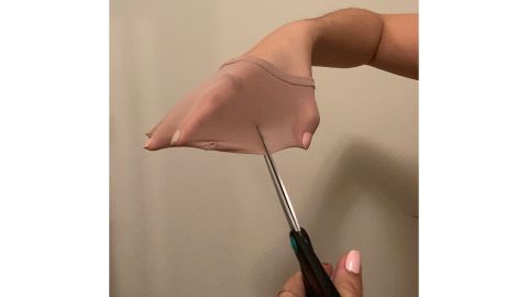 Attempting to cut the Sheertex tights with scissors