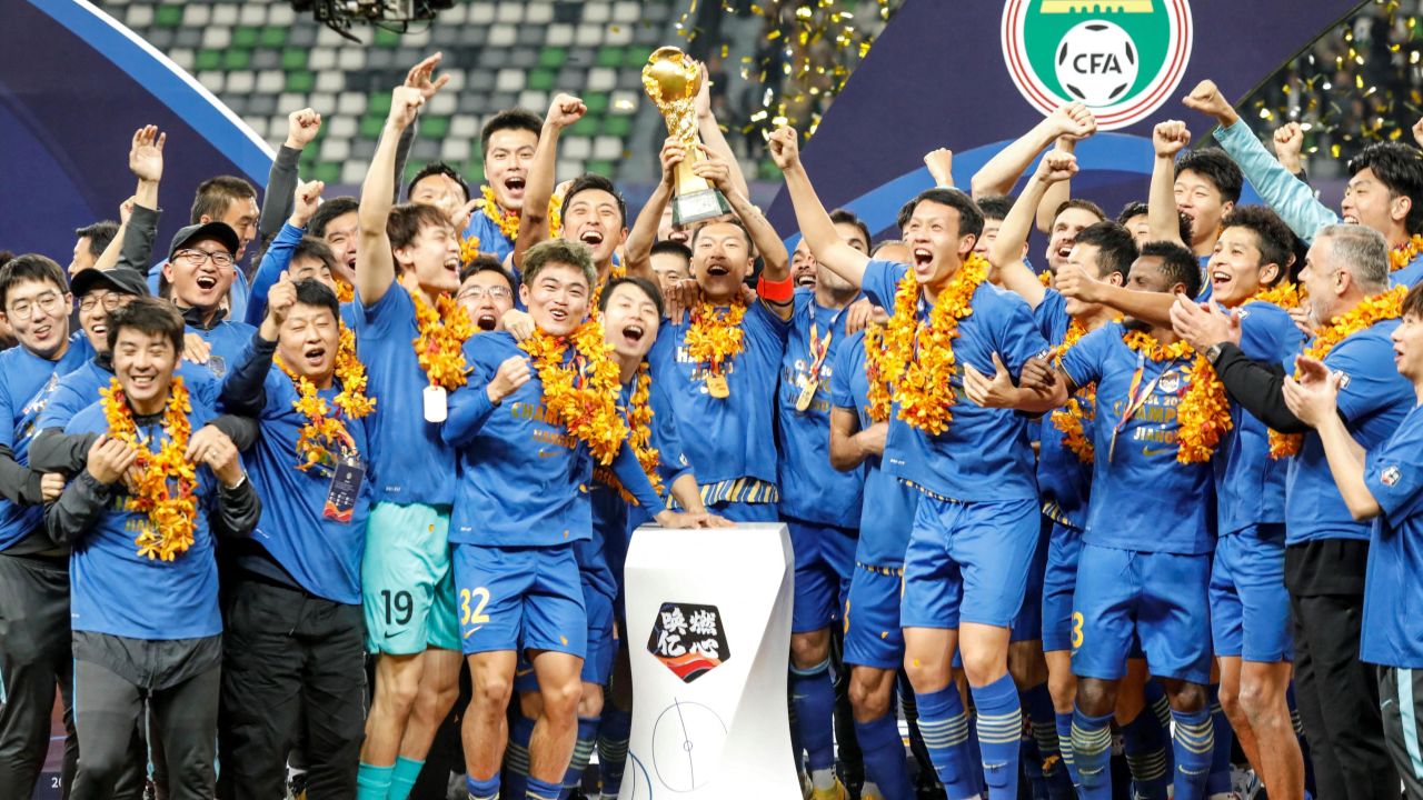 Jiangsu Suning players and staff celebrate after their team defeated Guangzhou Evergrande to win the Chinese Super League.