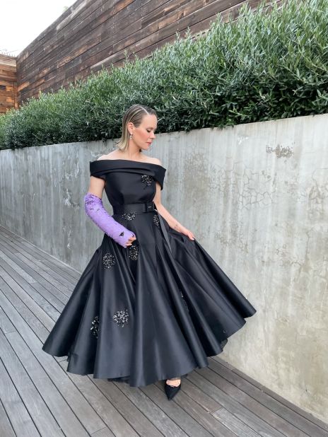 After reportedly injuring her arm while filming, Sarah Paulson turned her accident into an accessory by matching her embellished Prada gown with a custom, purple Prada cast. 