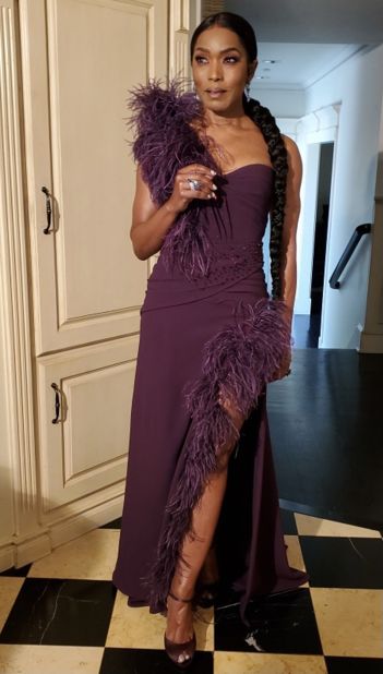 Angela Bassett embodied Old Hollywood glamour in a feather-trimmed Dolce and Gabbana gown.