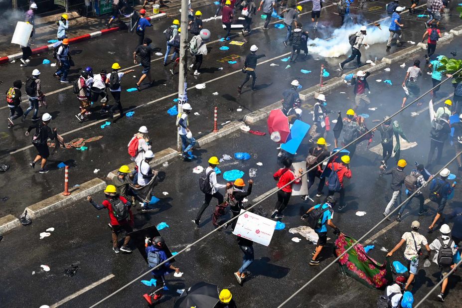 Protesters flee after tear gas was fired during a demonstration in Yangon on March 1.