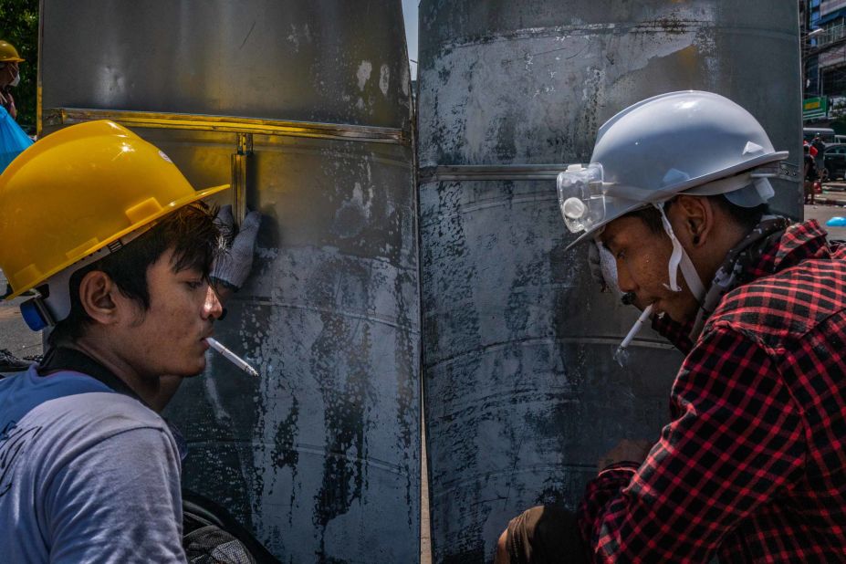 Protesters smoke behind shields during a demonstration in Yangon on March 1.