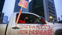 The words "Solidarity with Bessemer" are painted on a car as demonstrators participate in a Tax Amazon car caravan and bike brigade to defend a payroll-based tax on big businesses, including Amazon, that the City Council passed last July in Seattle, Washington on February 20, 2021. (Photo by Jason Redmond/AFP/Getty Images)