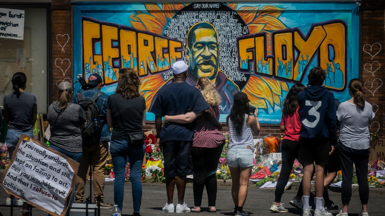 Visitors at a memorial featuring a mural of George Floyd, near the spot where he died in Minneapolis, Minnesota, on May 31, 2020.