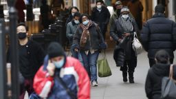 Pedestrian walk wearing face masks to protect from and to prevent the spread of the coronavirus on Wall Street in New York City on Monday February 22, 2021. COVID-19 deaths have now surpassed the 500,000 mark in the United States.